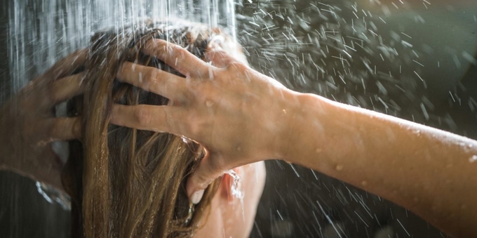 Woman washing hair in shower